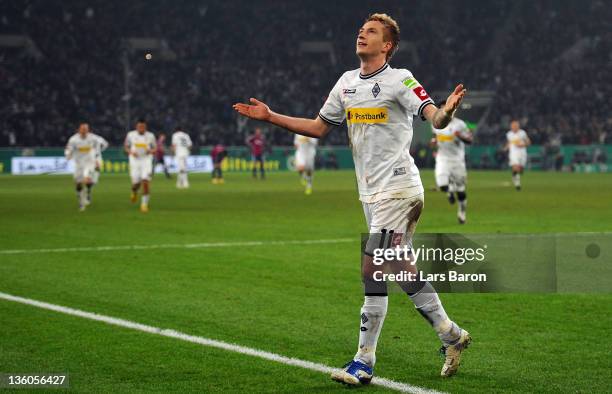 Marco Reus of Moenchengladbach celebrates after scoring his teams third goal during the DFB Cup round of sixteen match between Borussia...