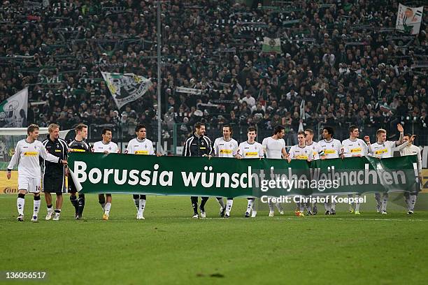 The team of Moenchengladbach celebrates the 3-1 victory with a banner after the DFB Cup round of sixteen match between Borussia Moenchengladbach and...