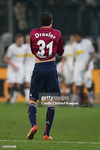 Julian Draxler of Schalke looks dejected after Gladbach scored the third goal during the DFB Cup round of sixteen match between Borussia...