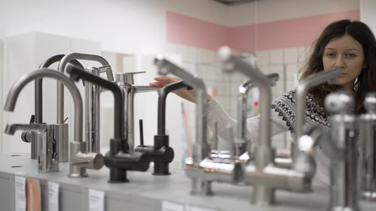 https://media.gettyimages.com/id/1360572225/video/young-woman-choosing-bathroom-faucet-in-hardware-store.jpg?b=1&s=640x640&k=20&c=9NRayqUlKib868giG8t_K49sOikTjTswbWN2ACRkIBk=