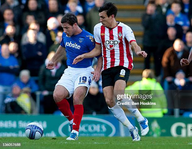 David Norris of Portsmouth holds off the challenge of Jack Cork of Southampton during the npower Championship match between Portsmouth and...