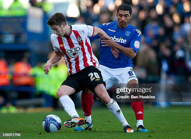 Adam Lallana of Southampton holds off the challenge of Hayden Mullins of Portsmouth during the npower Championship match between Portsmouth and...
