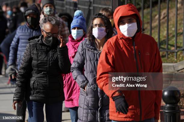 Local residents wait in-line to receive free COVID test kits outside Petworth Library on December 23, 2021 in Washington, DC. The City of District of...