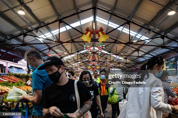 People walk through the vegetables section at the Queen Victoria Market on December 24, 2021 in Melbourne, Australia. Victoria has reintroduced rules...