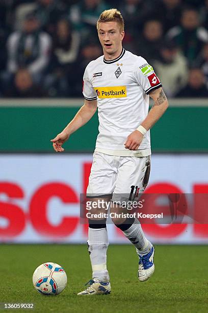 Marco Reus of Moenchengladbach runs with the ball during the DFB Cup round of sixteen match between Borussia Moenchengladbach and FC Schalke 04 at...