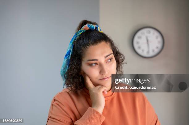 young woman portrait at home. she looks sad and thoughtful - good; times bad times stock pictures, royalty-free photos & images