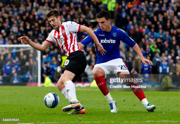Adam Lallana of Southampton is put under pressure by George Thorne of Portsmouth during the npower Championship match between Portsmouth and...
