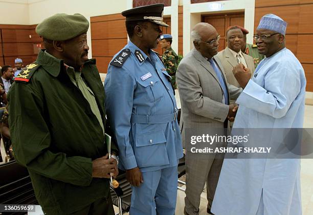 Special representative of the joint UN-African Union peacekeeping mission Ibrahim Gambari talks to unidentified Sudanese officials during the...