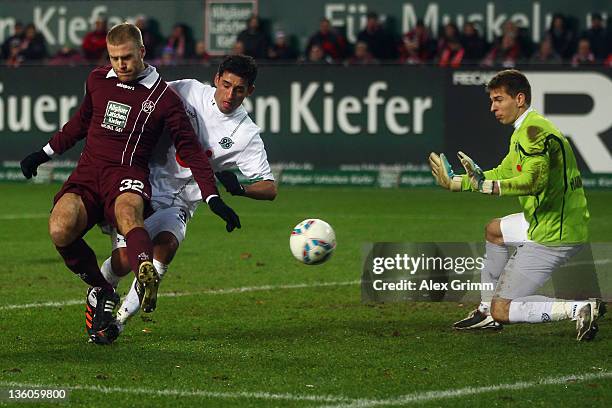 Adam Nemec of Kaiserslautern tries to score against Karim Haggui and goalkeeper Ron-Robert Zieler of Hannover during the Bundesliga match between 1....