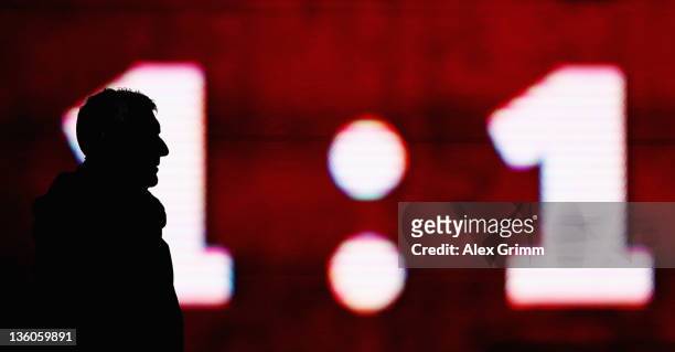 Head coach Mirko Slomka of Hannover is silhouetted during the Bundesliga match between 1. FC Kaiserslautern and Hannover 96 at Fritz-Walter Stadium...