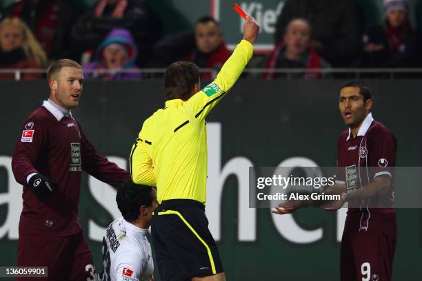 Itay Shechter of Kaiserslautern is sent off by referee Felix Brych during the Bundesliga match between 1. FC Kaiserslautern and Hannover 96 at...