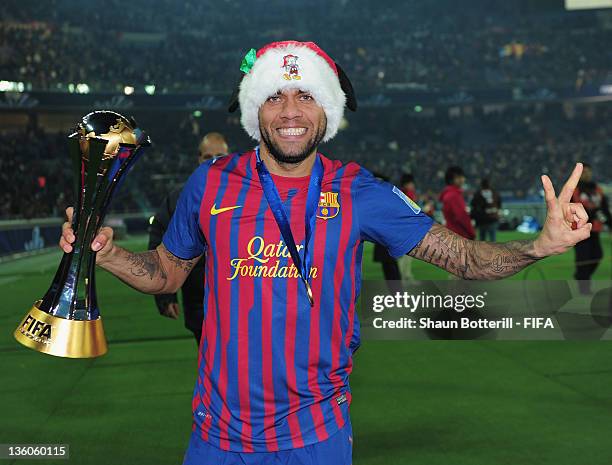 Dani Alves of Barcelona celebrates with the trophy after the FIFA Club World Cup Final match between Santos and Barcelona at the Yokohama...