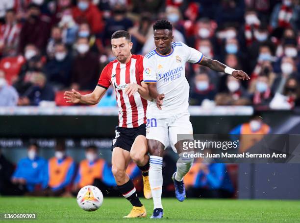 Vinicius Junior of Real Madrid duels for the ball with Oscar De Marcos of Athletic Club during the LaLiga Santander match between Athletic Club and...