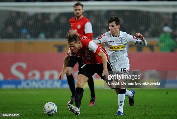 Eugen Polanski of Mainz is chased by Havard Nordtveit of Moenchengladbach during the Bundesliga match between Borussia Moenchengladbach and FSV Mainz...