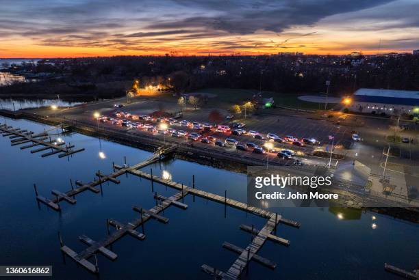 In an aerial view, health workers administer COVID-19 PCR tests at an outdoor testing site aside the Long Island Sound on December 23, 2021 in...
