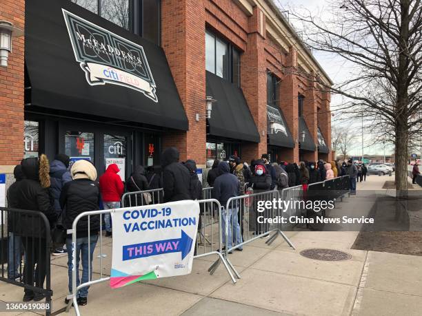 People queue up outside a COVID-19 vaccination site in the Queens borough on December 23, 2021 in New York City.