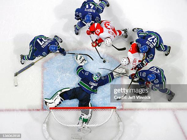 Darren Helm of the Detroit Red Wings tries to take a shot at a stickless Roberto Luongo of the Vancouver Canucks during their NHL game at Roger s...