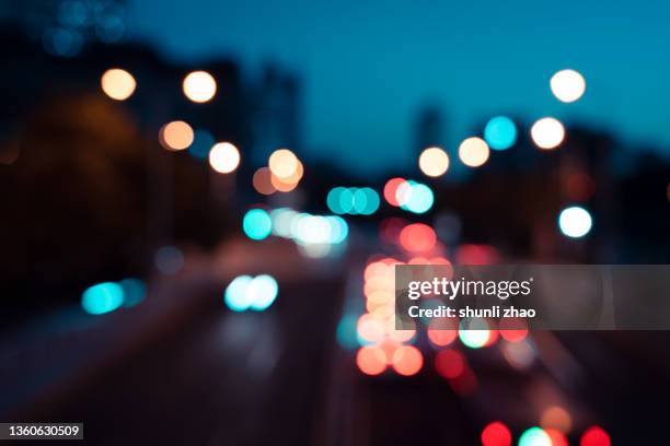 defocused image of illuminated city at night - grand lit stock pictures, royalty-free photos & images