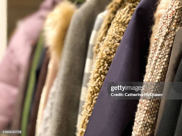 row of coats (some vintage) hanging in coat closet - winter jacket stock pictures, royalty-free photos & images