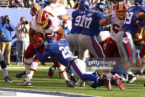 Darrel Young of the Washington Redskins scores a touchdown as Antrel Rolle of the New York Giants misses the tackle during their game at MetLife...