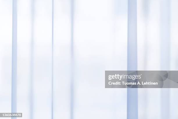 light coming through a sheer, transparent and pleated light blue curtains or drapes. - tecido transparente imagens e fotografias de stock
