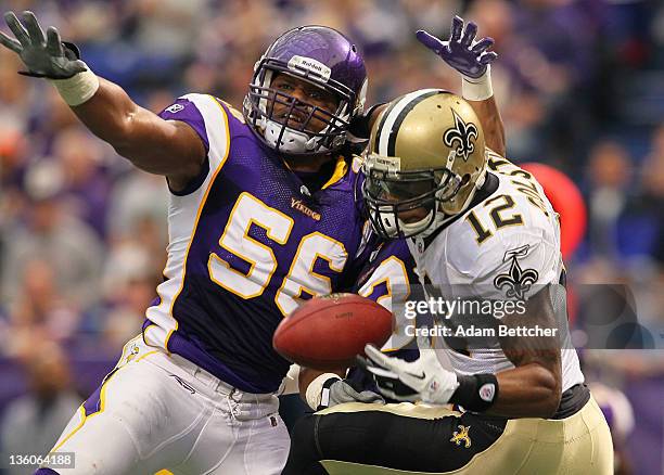 Henderson of the Minnesota Vikings attempts to disrupt the pass to Marques Colston of the New Orleans Saints at the Hubert H. Humphrey Metrodome on...
