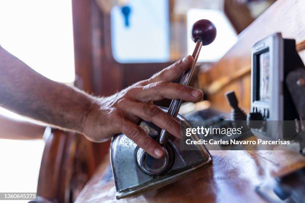 hand of a male pushing a lever while driving a boat - lever stock pictures, royalty-free photos & images