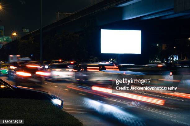 blank billboard on city street at night. outdoor advertising - billboard night photos et images de collection