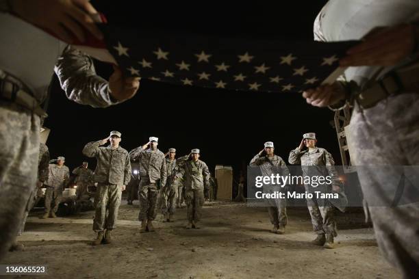 Soldiers from the 3rd Brigade, 1st Cavalry Division salute during a re-enlistment ceremony for Staff Sergeant Brant Smith, from Dothan, Alabama,...