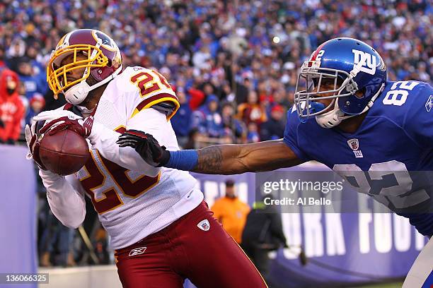 Josh Wilson of the Washington Redskins catches aninterception against Mario Manningham of the New York Giants during their game at MetLife Stadium on...