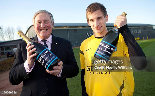 Marc Albrighton of Aston Villa with David Strudley, chief executive of Acorns Children's Hospice, the recipient of a cheque presented to the Villa...