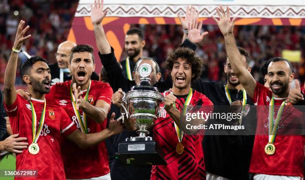 Ahly's players celebrate with the winners trophy during the CAF Super Cup football match between Egypt's Al-Ahly and Morocco's Raja Club Athletic at...