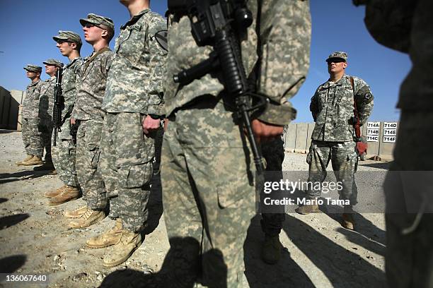 Soldiers from the 3rd Brigade, 1st Cavalry Division, attend a casing of the colors ceremony at Camp Adder, now known as Imam Ali Base, on December...