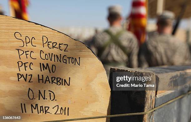 Soldiers from the 3rd Brigade, 1st Cavalry Division, attend a casing of the colors ceremony by handwritten names of soldiers at Camp Adder, now known...