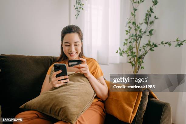 young woman using credit card payment - credit card debt stockfoto's en -beelden