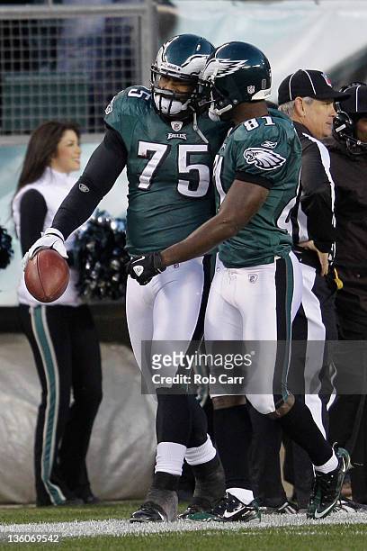 Juqua Parker of the Philadelphia Eagles celebrates with Jason Avant after Parker returned a fumble for a touchdown against the New York Jets at...