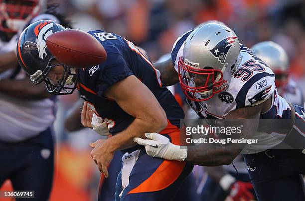 Quarterback Tim Tebow of the Denver Broncos fumbles the ball as he is hit by defensive end Mark Anderson of the New England Patriots who recovered...