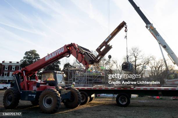 Construction crews dismantle the base of the pedestal that held a statue of Confederate General Robert Lee on December 16, 2021 in Richmond,...