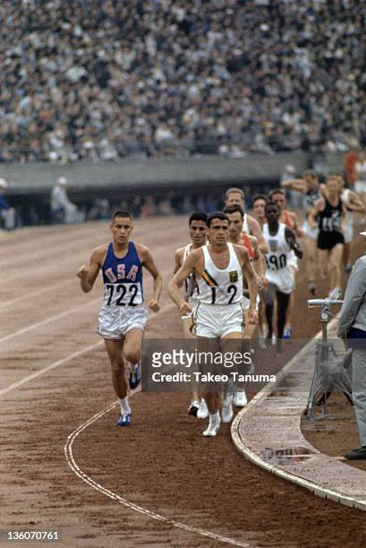 Summer Olympics: USA Billy Mills and Australia Ron Clarke in action during Men's 10,000M Final at National Olympic Stadium. Sequence. Tokyo, Japan...