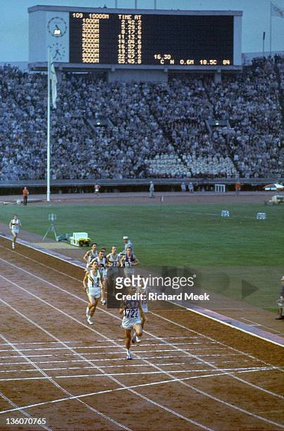 Summer Olympics: USA Billy Mills approaching finish line vs Australia Ron Clarke and Tunisia Mohamed Gamoudi during Men's 10,000M Final at National...