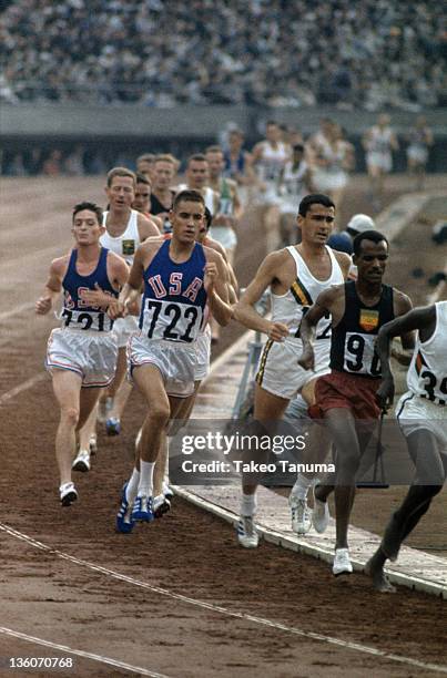 Summer Olympics: USA Billy Mills and Australia Ron Clarke in action during Men's 10,000M Final at National Olympic Stadium. Sequence. Tokyo, Japan...