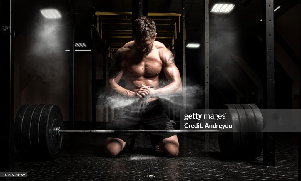 Muscular man clapping hands and preparing for workout