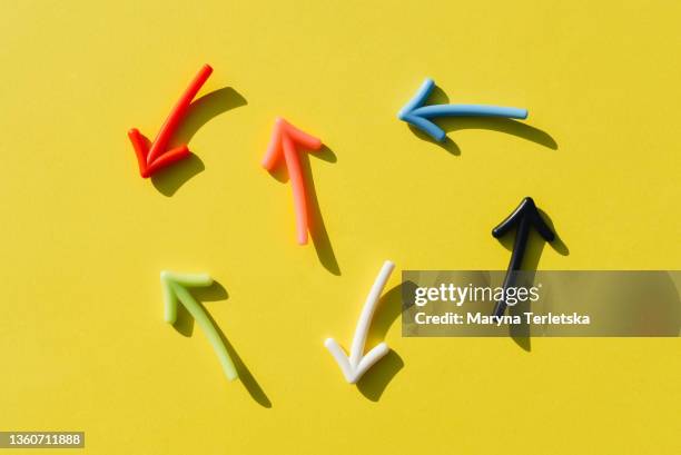 multicolored flatley arrows on yellow background. multicolored arrows on a yellow background. - duplex stockfoto's en -beelden