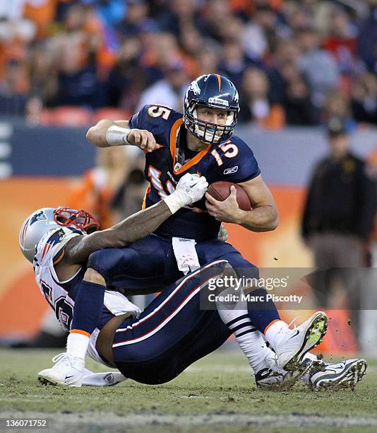 Tim Tebow of the Denver Broncos is sacked by Mark Anderson of the New England Patriots on December 18, 2011 during the second half at Sports...