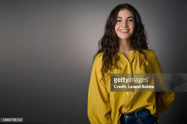 studio portrait of young adult caucasian woman - yellow blouse foto e immagini stock