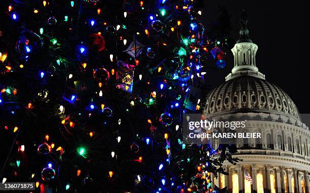 The US Capitol dome and Christmas tree are seen December 18, 2011 in Washington. US President Barack Obama on Sunday faced a new congressional...