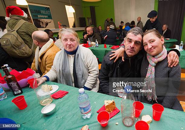 An homeless couple poses for a picture during a Christmas Lunch perpared by the Restaurant, La Ragnatela at Centro Sociale Rivolta on December 22,...