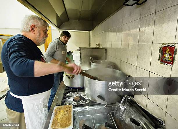 Chefs of the Restaurant, La Ragnatela prepare Rice with Radicchio for Christmas Lunch for the Homeless at Centro Sociale Rivolta on December 22, 2011...