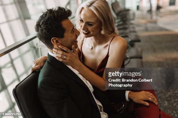 public display of affection in an airport - brandon reddish stock pictures, royalty-free photos & images