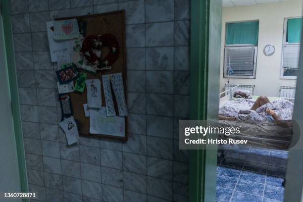 Christmas postcards from children hang on the wall of a patient's room in the COVID-19 unit at Saint Mina Hospital on December 24, 2021 in Plovdiv,...